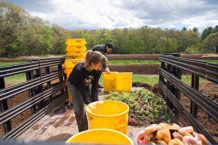 Students working with compost in the bed of a truck